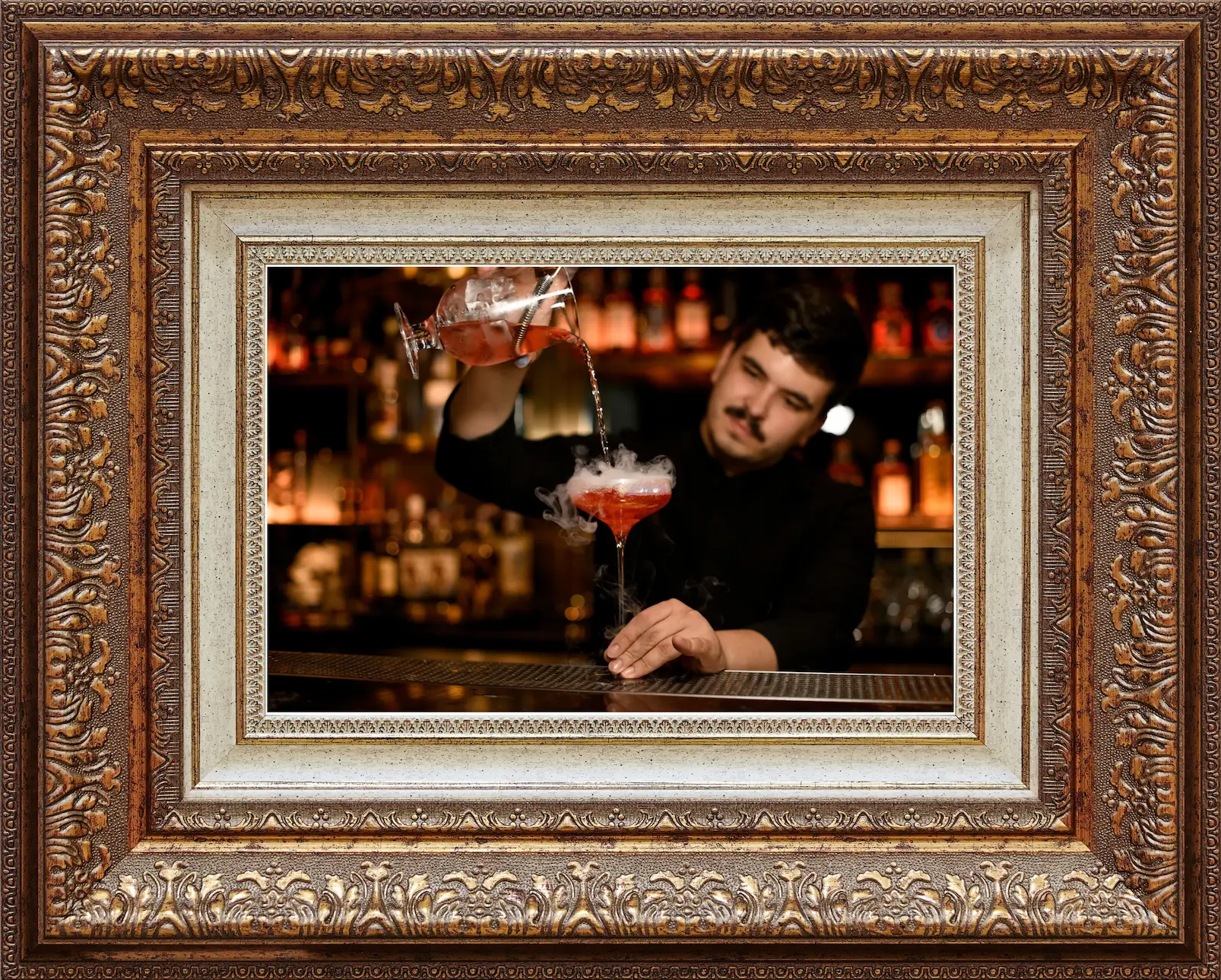 Image of bartender pouring cocktail from a cocktail shaker